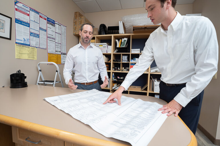 Underwriting team looking at blueprints